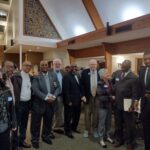 2023 Annual Banquet, Mayor Williams, Councilwoman Javiera Caballero, Dr. Warren Herndon, Rev. Joe Harvard, and others in a group photo in a fellowship hall.